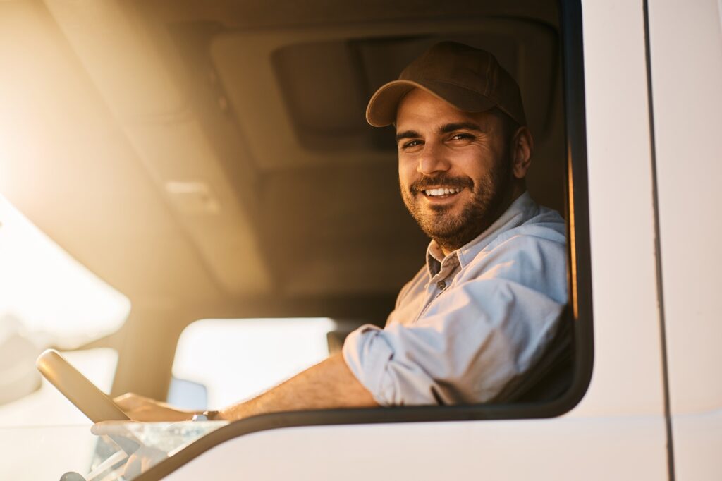 Portrait of happy truck driver looking at camera.